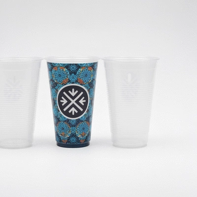 Custom printed plastic cups with a unique logo next to plain standard wholesale plastic cups on a clean background